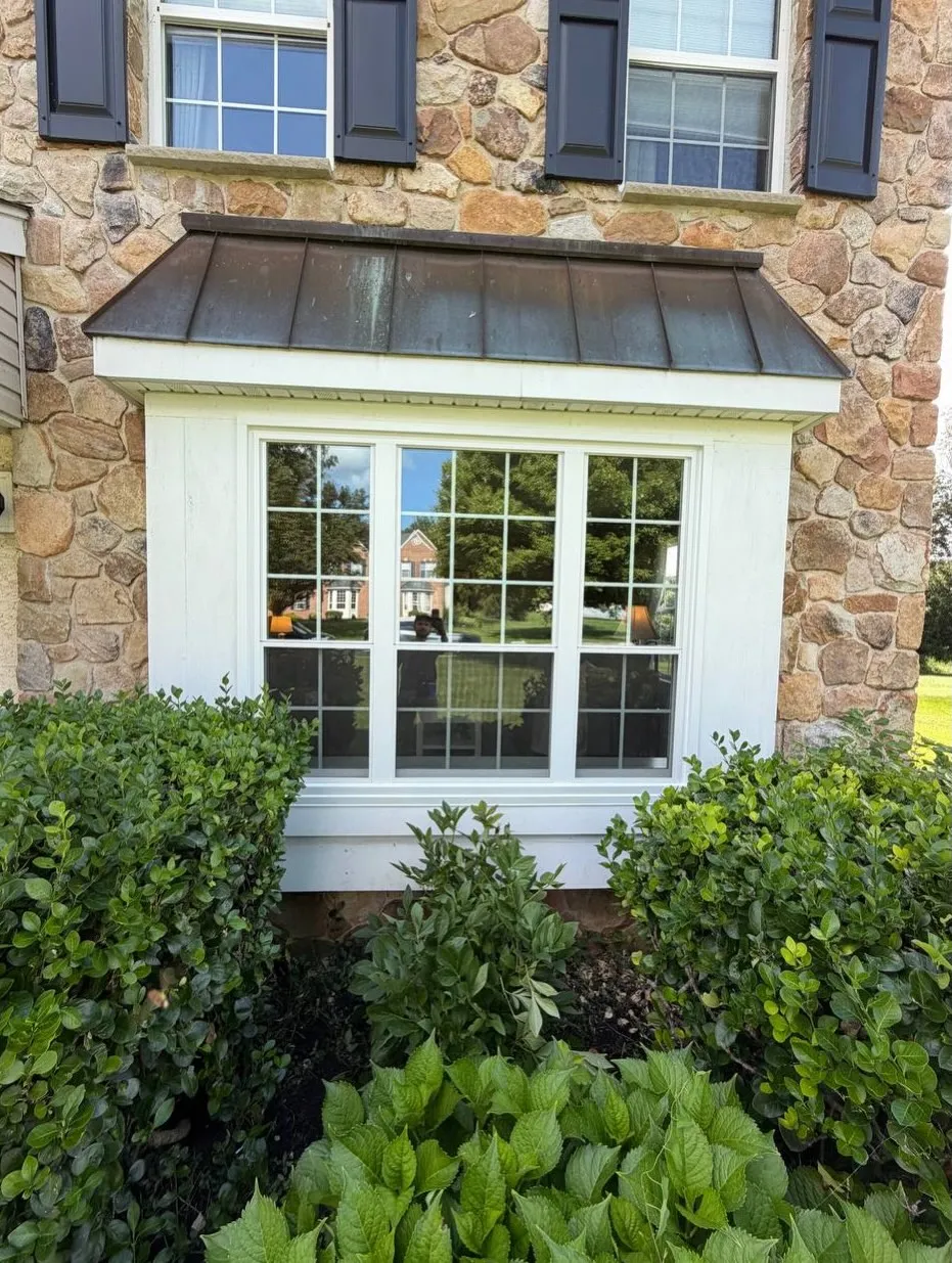 Bay window: Copper roof on a fieldstone colonial. Installed by HomeTrust Windows & Doors.