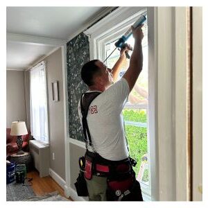 HomeTrust Windows and Doors installer setting a replacement window inside a Pennsylvania home