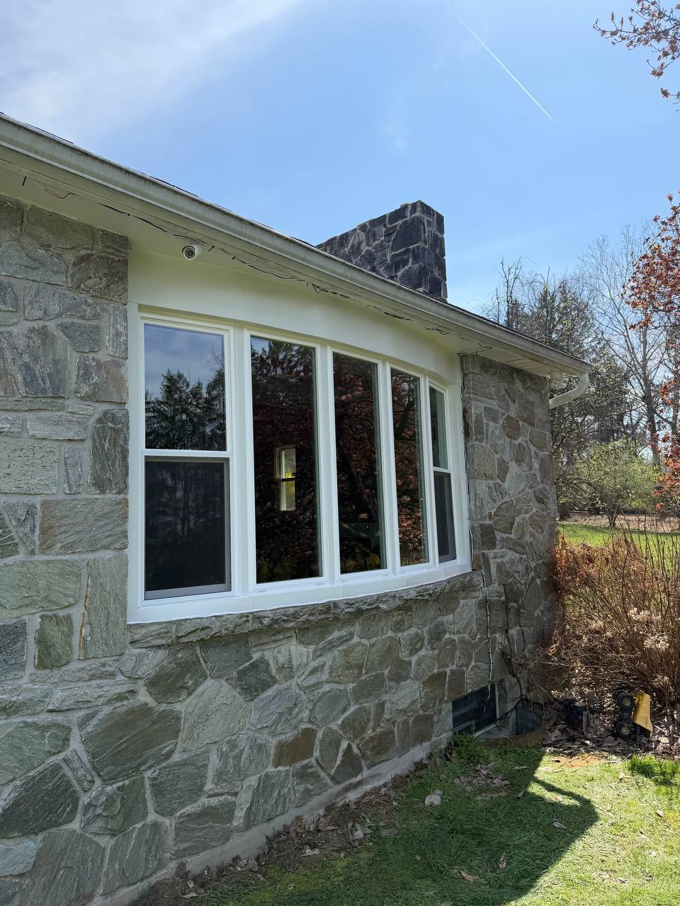 Replacement bow window installed by HomeTrust Windows and Doors in a stone home near Philadelphia, PA