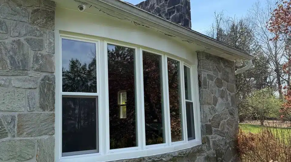 Five-lite bow replacement window installed by HomeTrust in a stone home exterior wall
